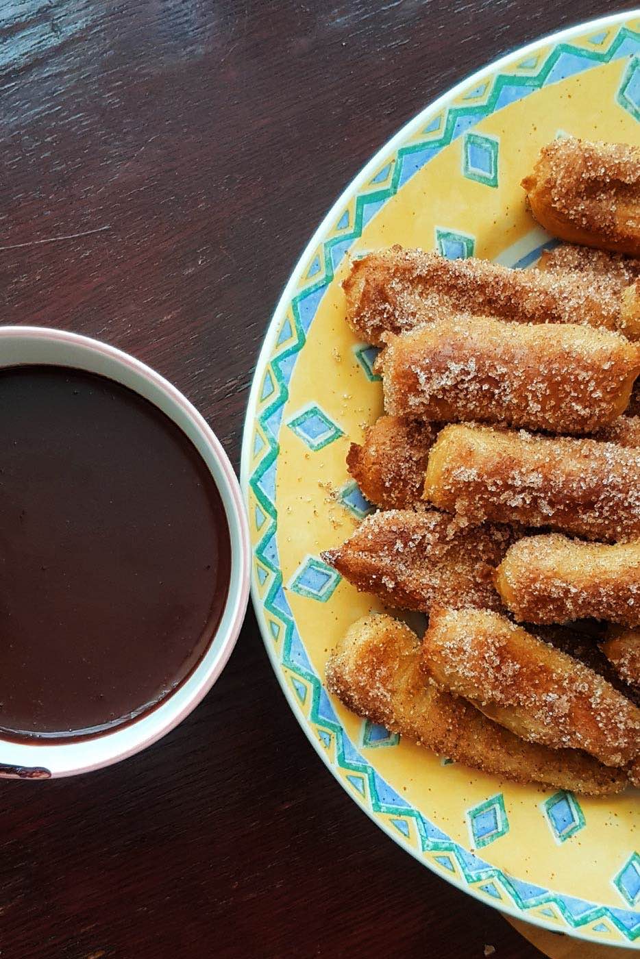 homemade baked churros and chocolate sauce dip